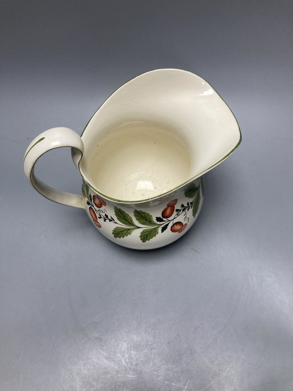 A group of Wedgwood Queensware, 19th century, including ten strawberry plates, a coaster, a jug and six drabware plates